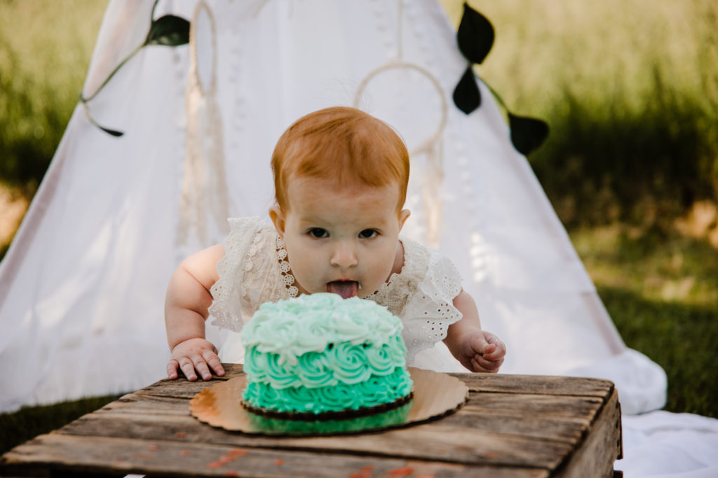 Baby smashing face first into birthday cake