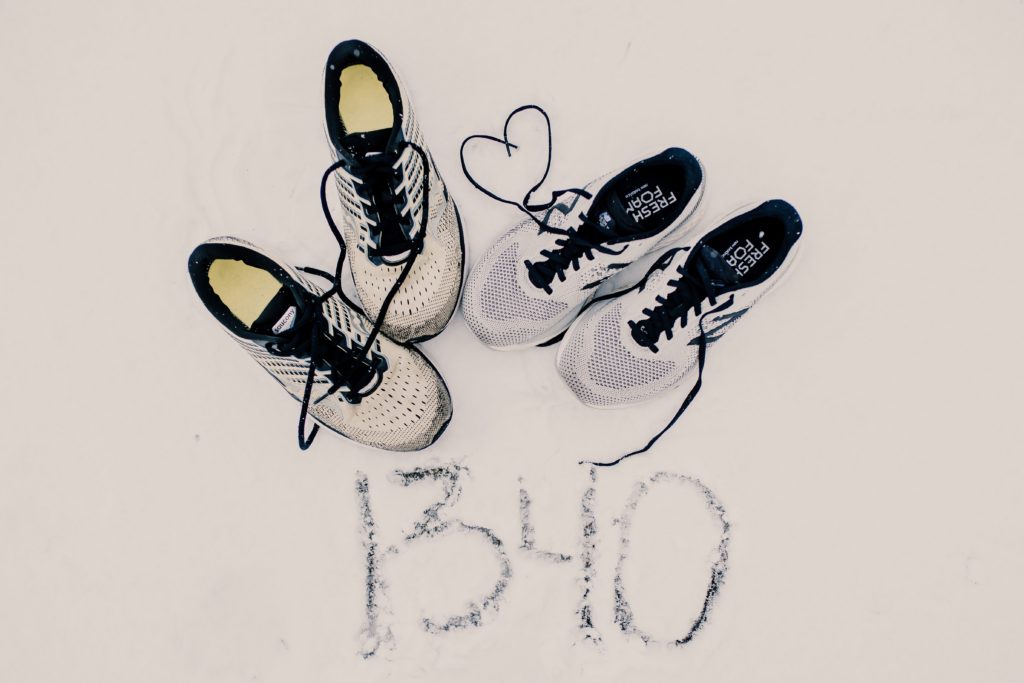 picture of couples running shoes with 1340 miles written in snow