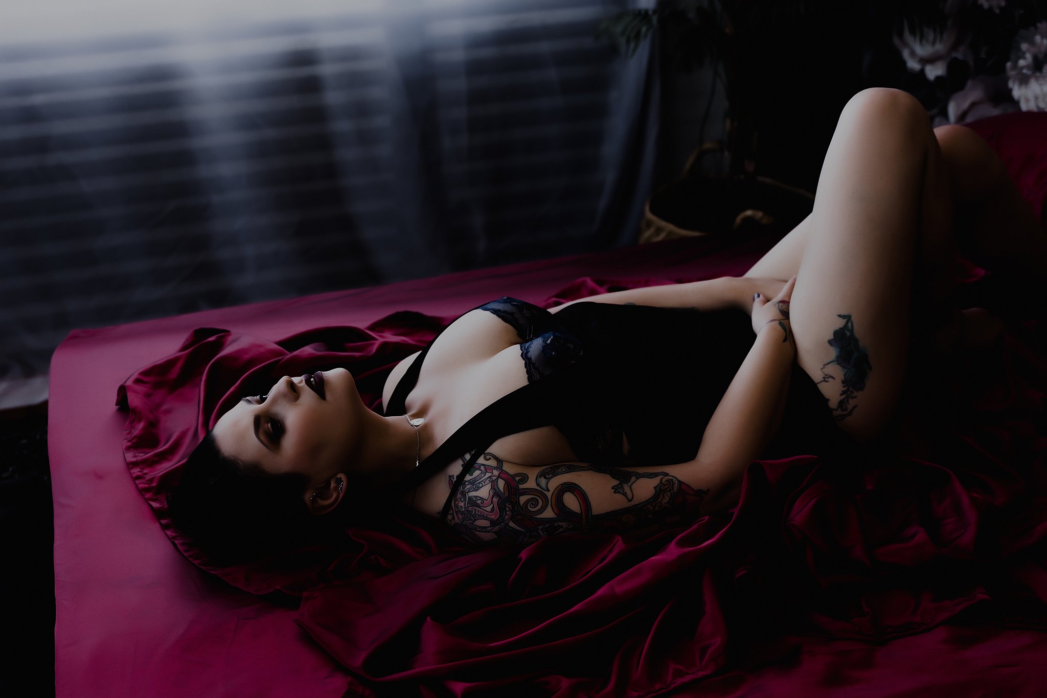 women laying on bed in lingerie