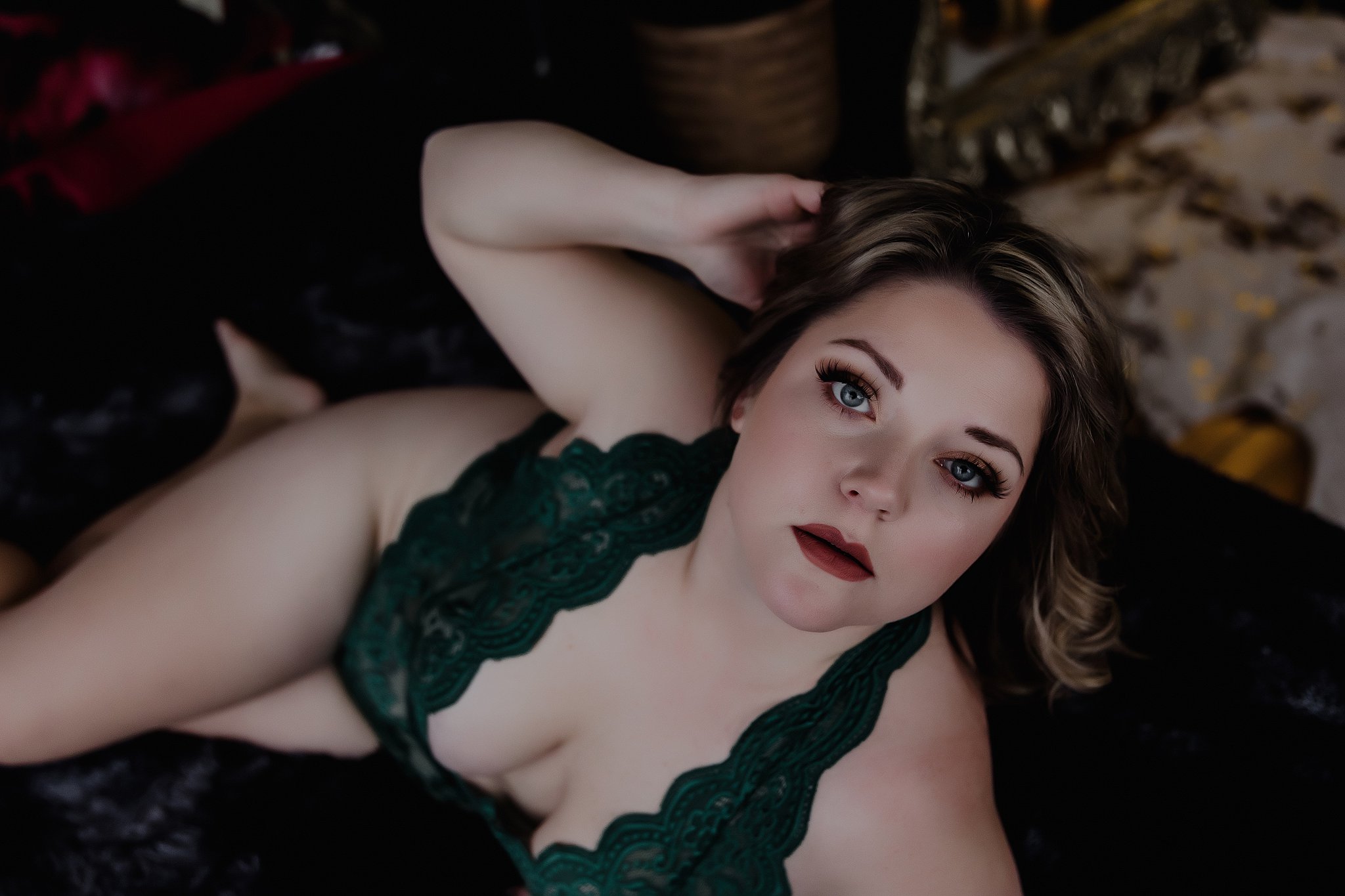 women in green lingerie on bed with big eyes
